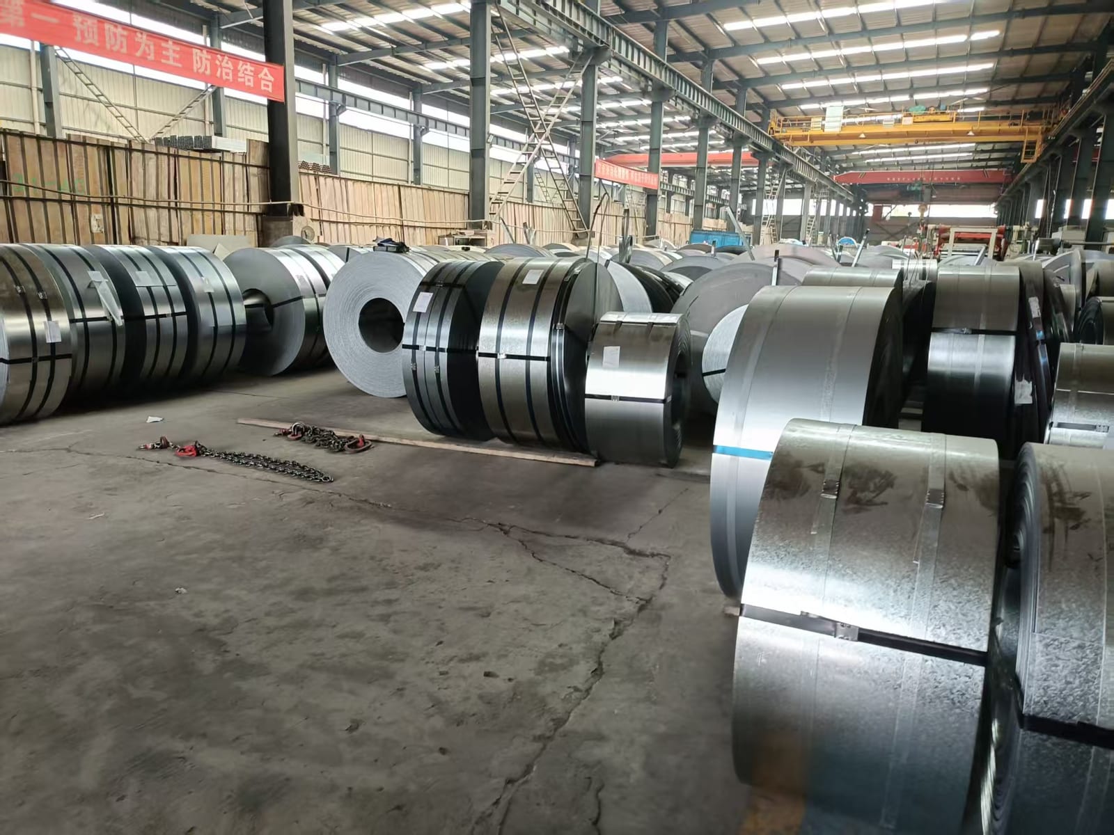 Hot-dip galvanized steel coils stored in a mill warehouse bay